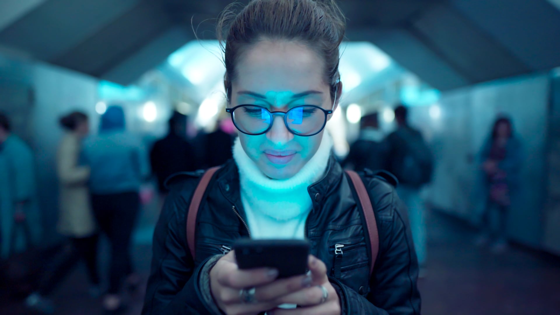 woman_standing_and_looking_at_a_smartphone_in_a_subway_tunnel_by_Roma_Black_Artgrid-HD_H264-HD